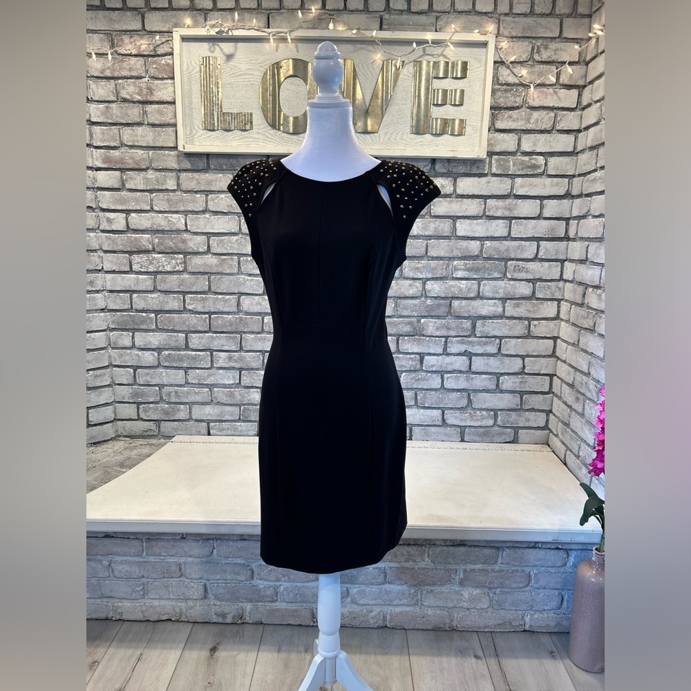 Fabulous figure flattering black dress with gold studded shoulder detailing.